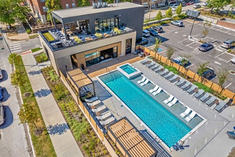 A modern building with a pool in the foreground.