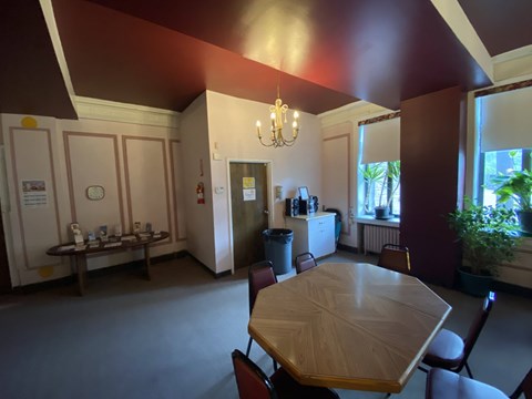 A dining room with a table and chairs.