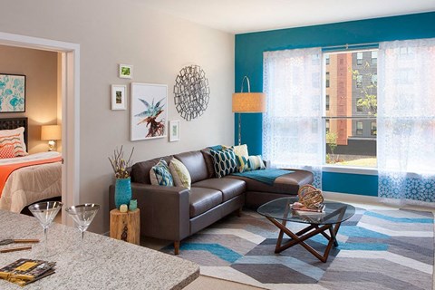 A living room with a brown couch and a coffee table.