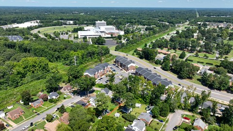 A bird's eye view of a residential area with a large building in the distance.