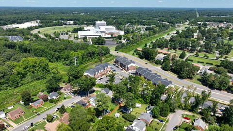 An aerial view of a residential area with a large building in the distance.