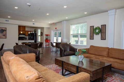 A living room with brown and tan couches and a coffee table.