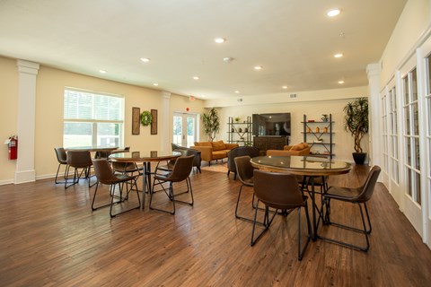 A dining room with a table and chairs.
