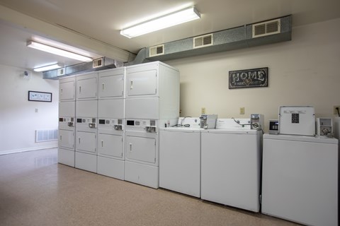 A row of white electrical panels are lined up in a room.