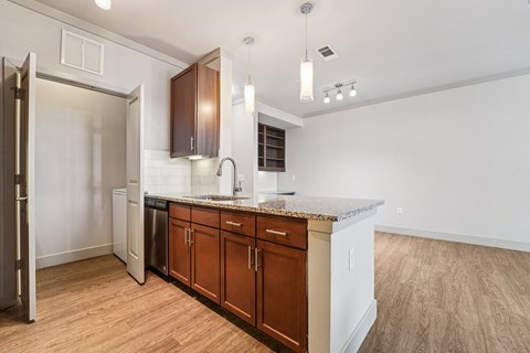A kitchen with wooden cabinets and a granite countertop.