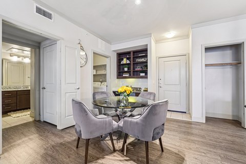 A dining room with a table set for two.