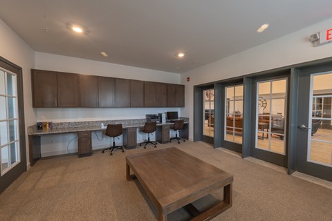 A conference room with a long table and chairs.