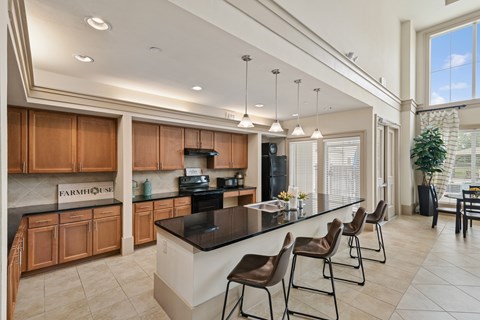 A kitchen with wooden cabinets and a black countertop.