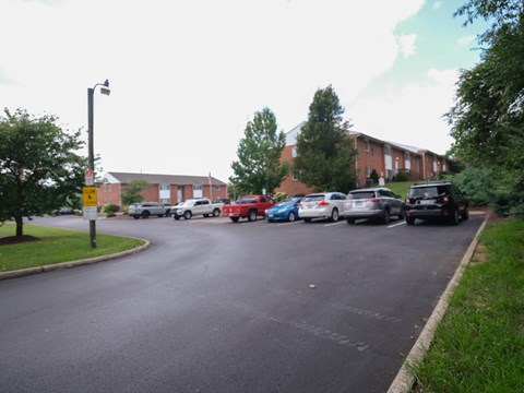 Cars parked on a street in front of a building.