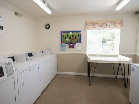 A laundry room with washers and dryers.