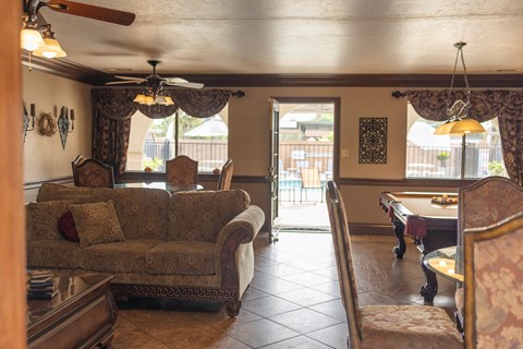 A living room with a couch, chairs, and a table.