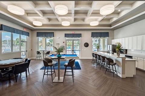 a large conference room with tables and chairs and a kitchen