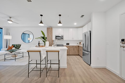 A modern kitchen with a dining table and chairs.