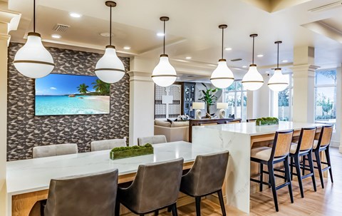 a kitchen with a bar and a beach view