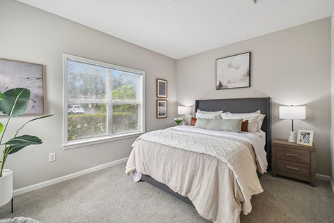 a bedroom with a bed and a large window