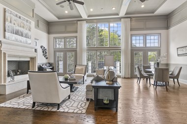 a living room filled with furniture and a large window - Photo Gallery 2