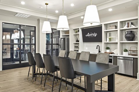 A modern kitchen with a dining table and chairs.
