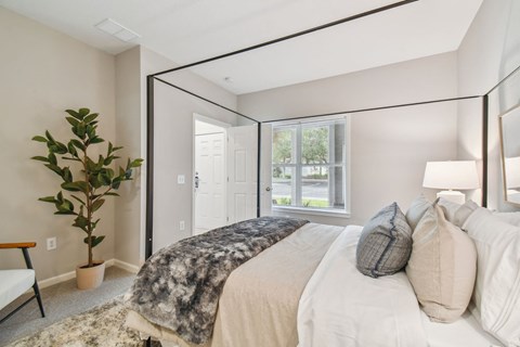 a bedroom with a large bed and a large mirror