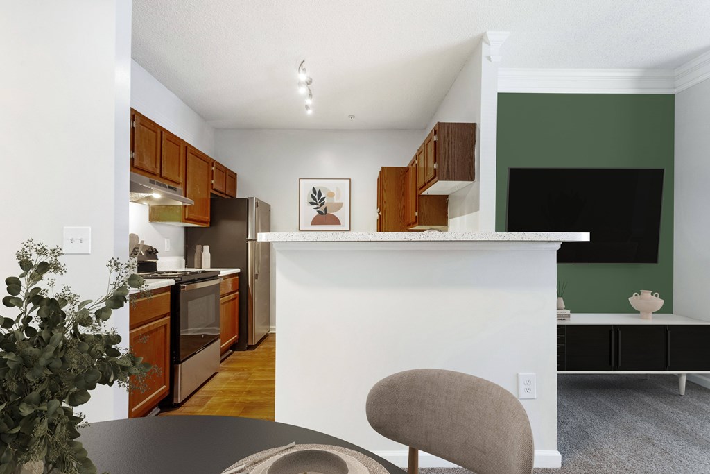 A kitchen with a white island and wooden cabinets.