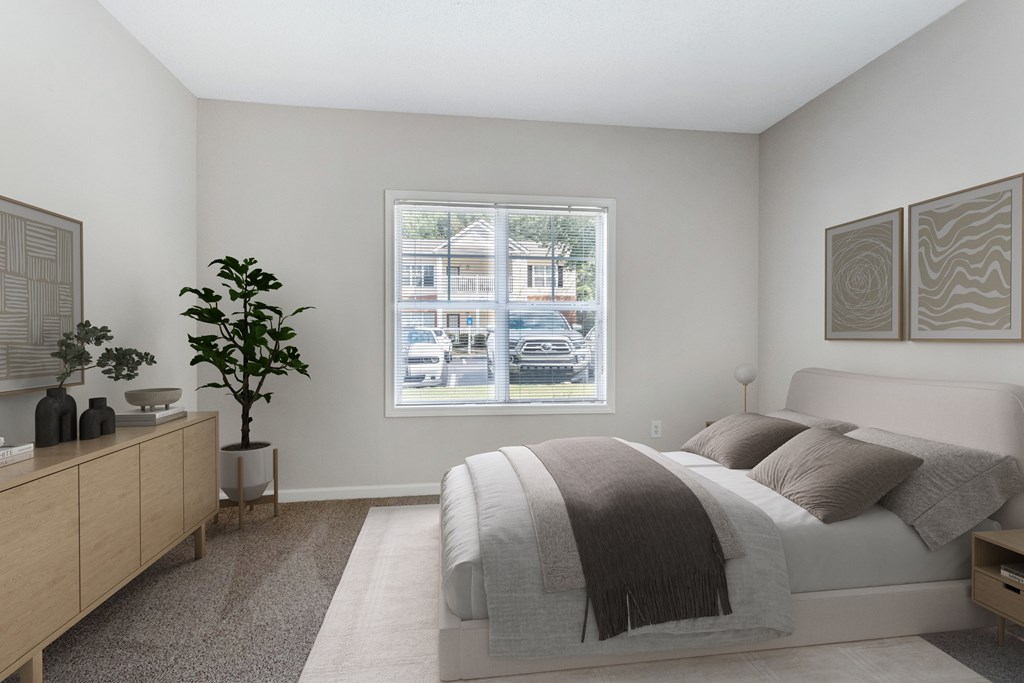 A bedroom with a large bed and a window overlooking a street.