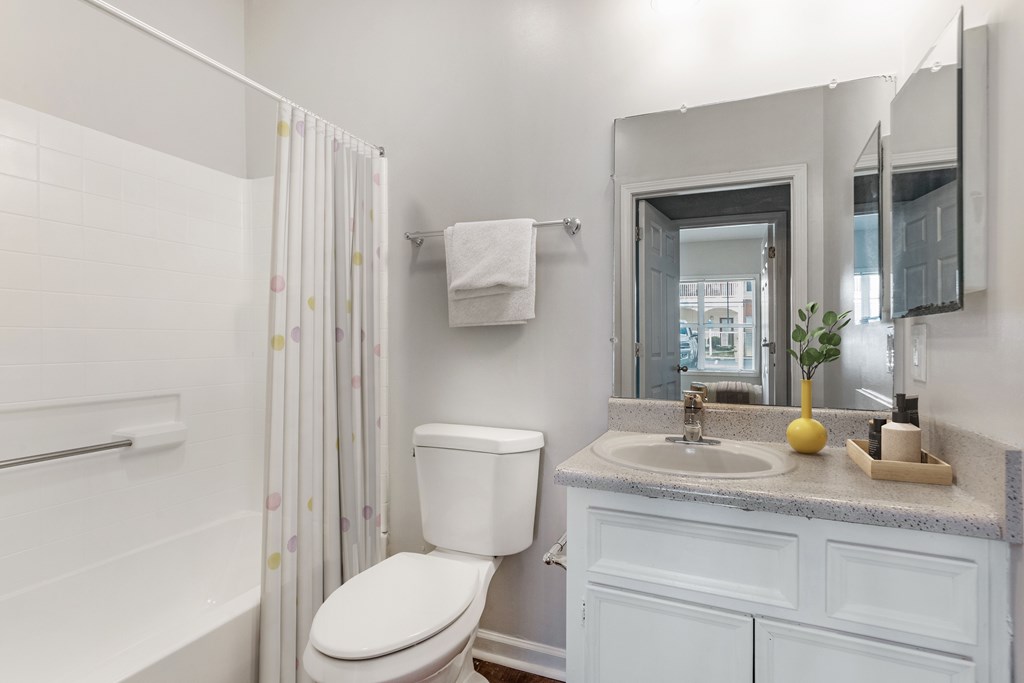A white toilet sits next to a sink in a bathroom.