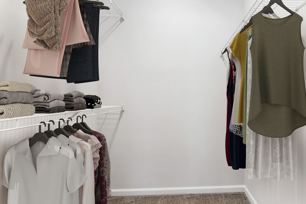Clothes hanging on a rack in a room.
