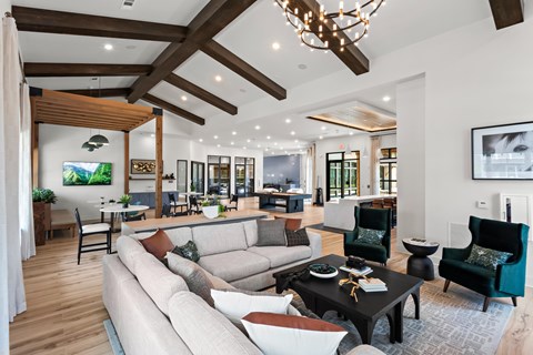 A modern living room with a large couch and a chandelier.
