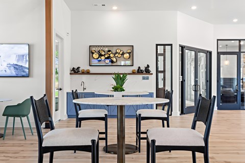A modern dining room with a table set for six.
