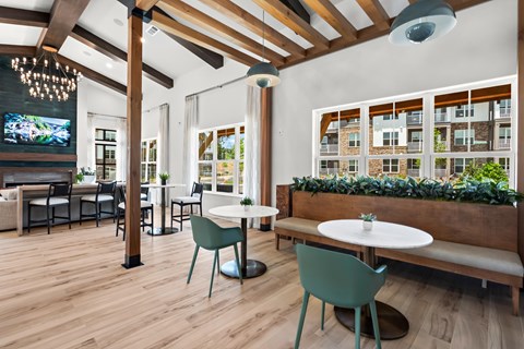 A modern dining area with a wooden floor and white walls.