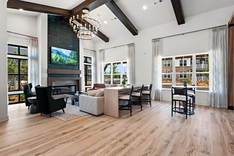 A modern living room with a fireplace and a large window.