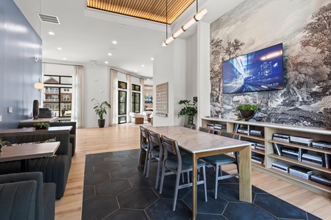 A modern dining room with a large table and chairs.