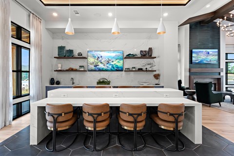 A modern kitchen with a bar area and a television mounted above the counter.