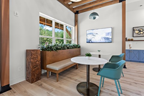 A room with a white table and blue chairs.