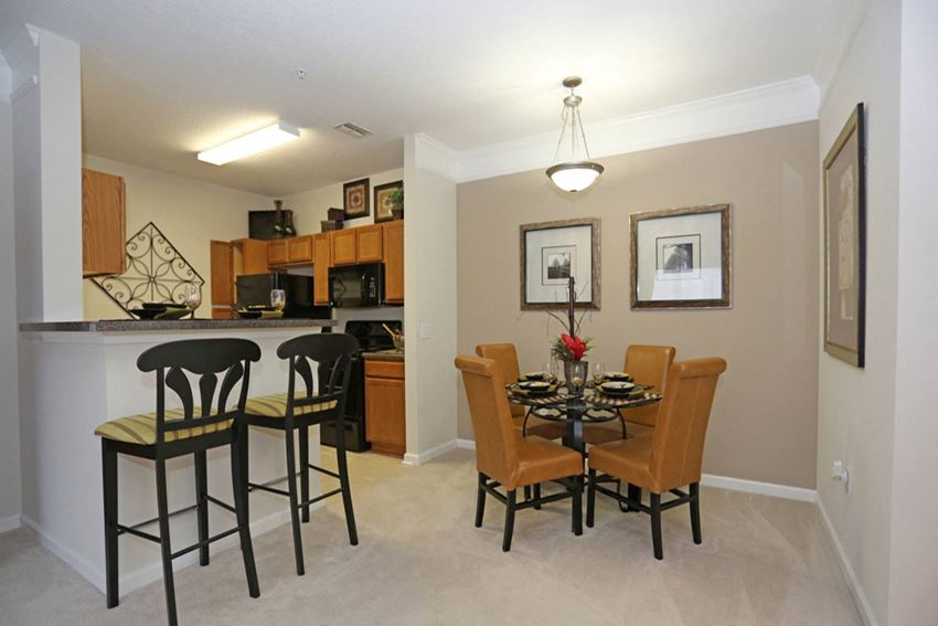 Open-concept dining room and kitchen Open-concept dining room and kitchen at The Columns at Cypress Point, Florida 33545