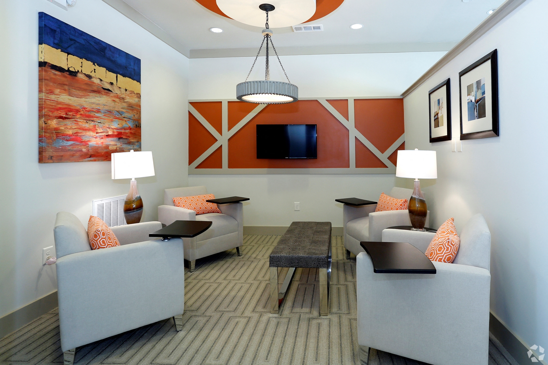 Modern lounge with seating for four and a TV at The Columns at Coldbrook Station, Georgia 31407