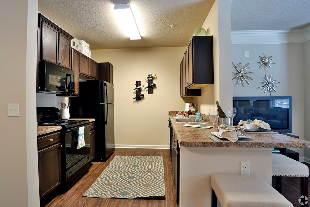 Semi-open concept kitchen with living room and dining room views at The Columns at Coldbrook Station, 31407