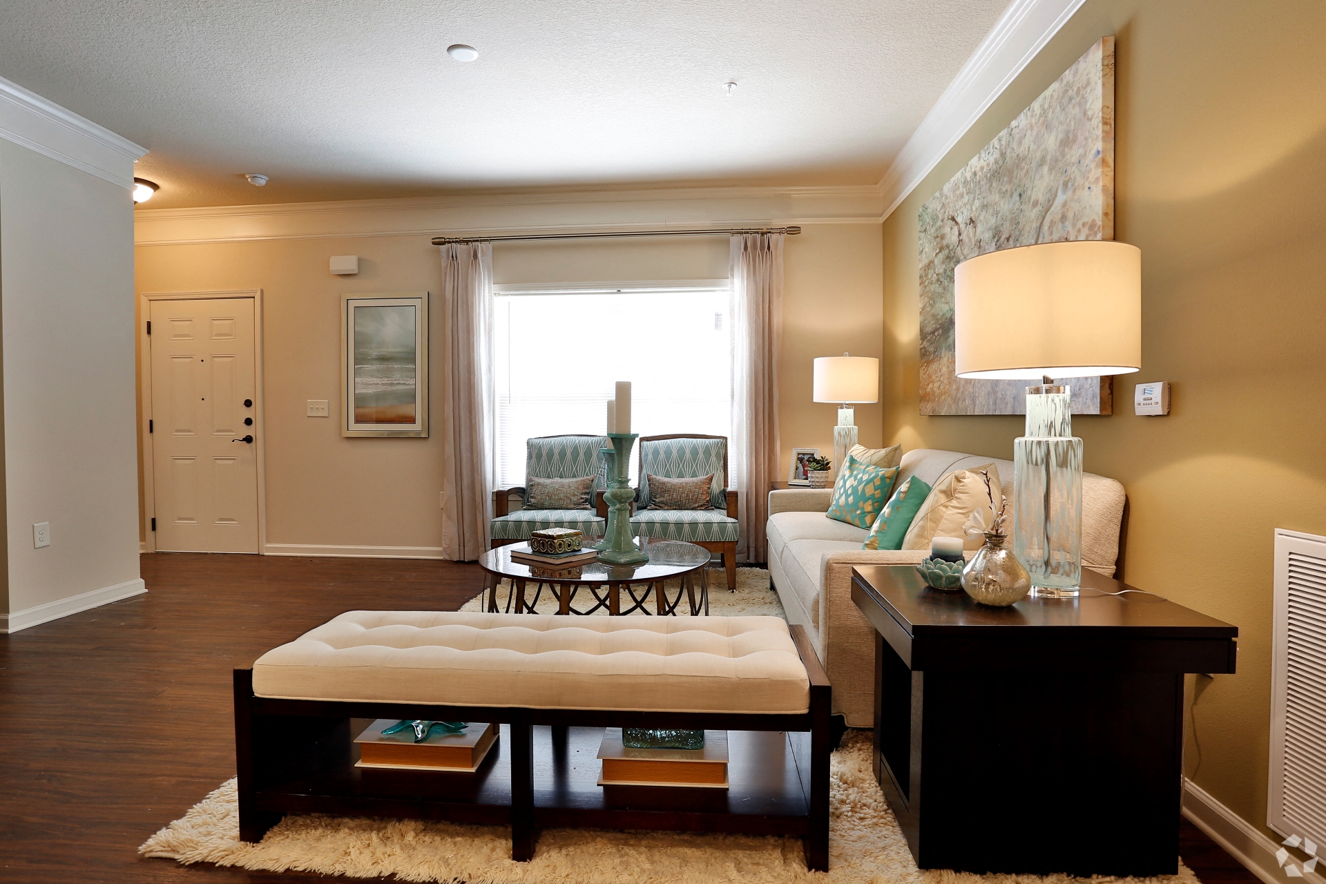 Spacious living room with modern decor and bright window at The Columns at Coldbrook Station, Georgia