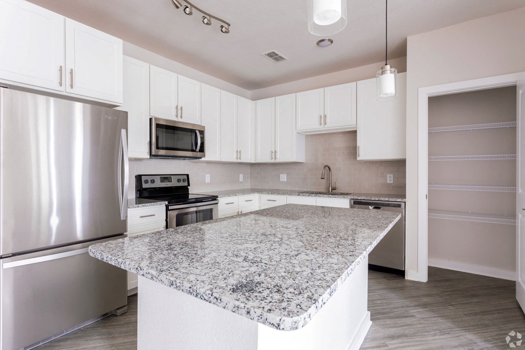 Modern kitchen with large island,at Estero Parc, Estero, FL, 33928