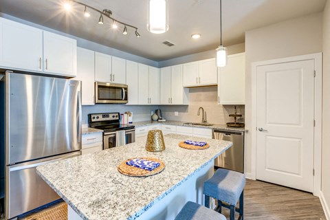 a kitchen with stainless steel appliances and granite counter tops