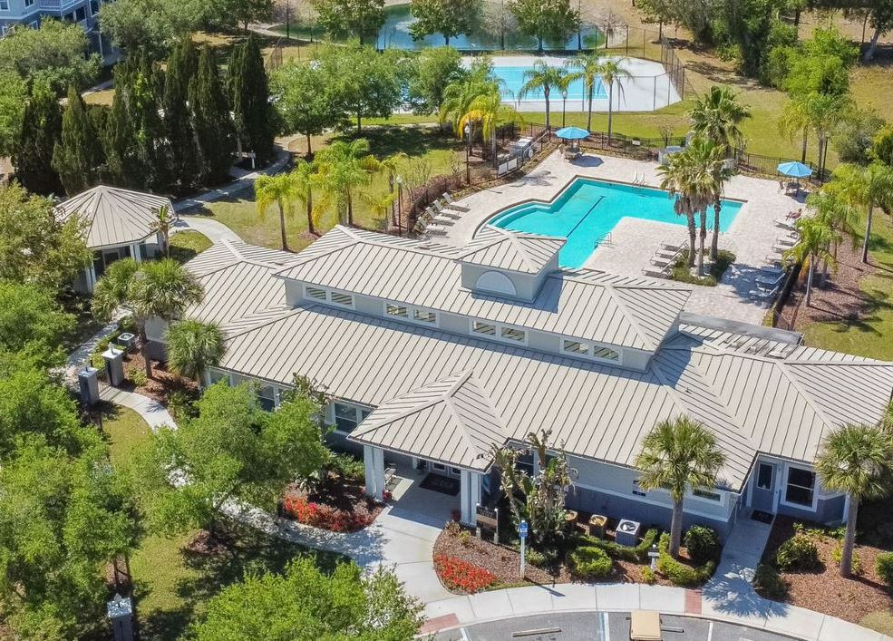 a house with a pool and trees in the background