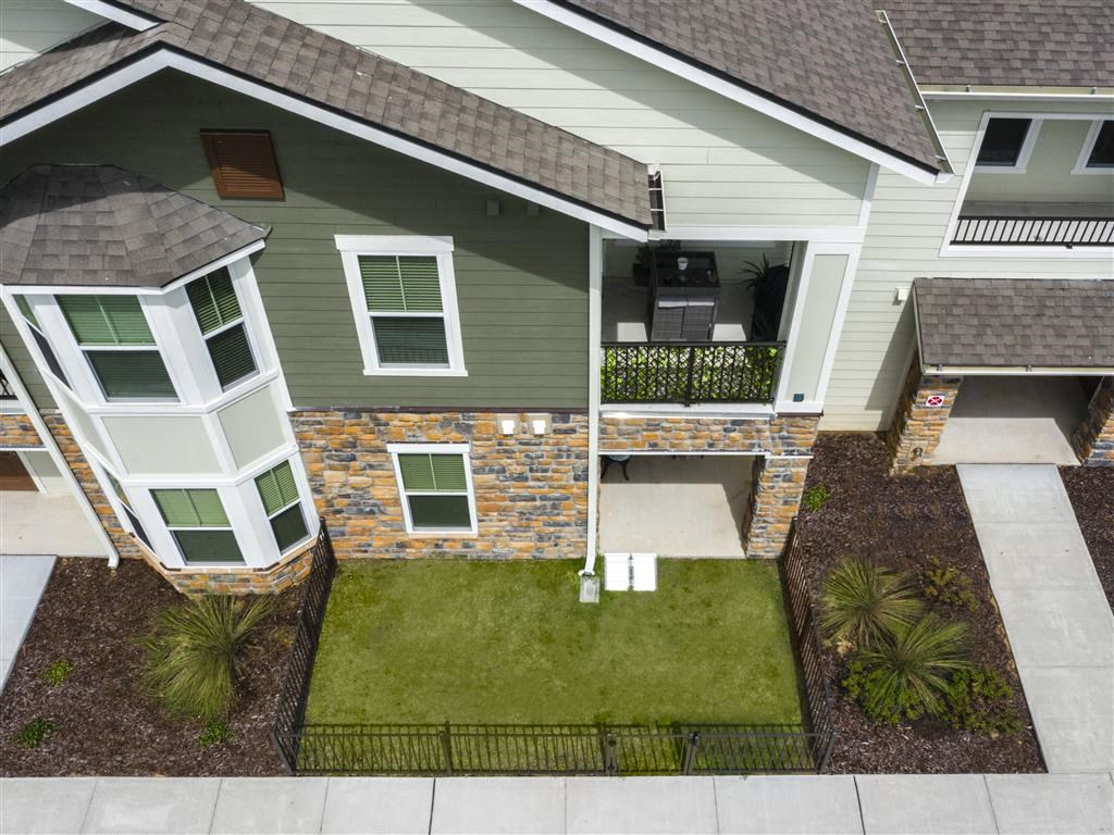 a house with a green lawn and a porch at Verso Apartments, Davenport, FL, 33896