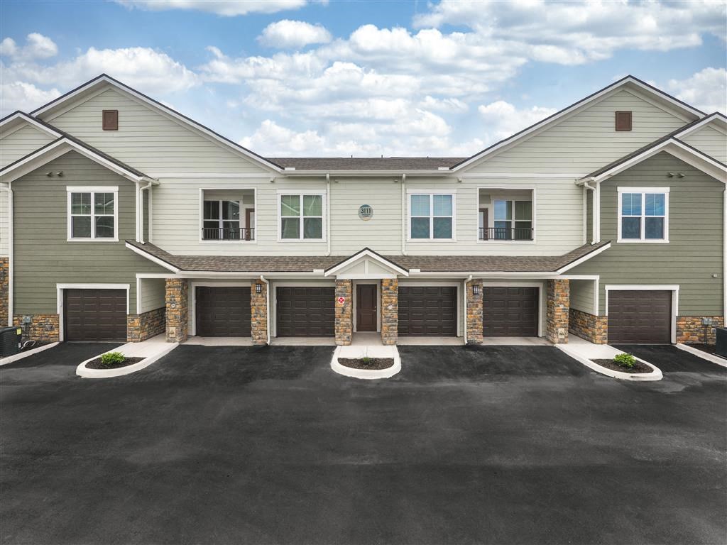 the front of a house with a drive way at Verso Apartments, Davenport