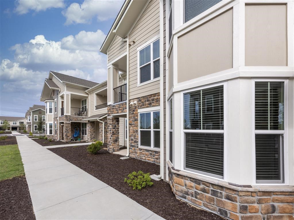 a row of townhomes with a sidewalk in front of them at Verso Apartments, Davenport, FL, 33896