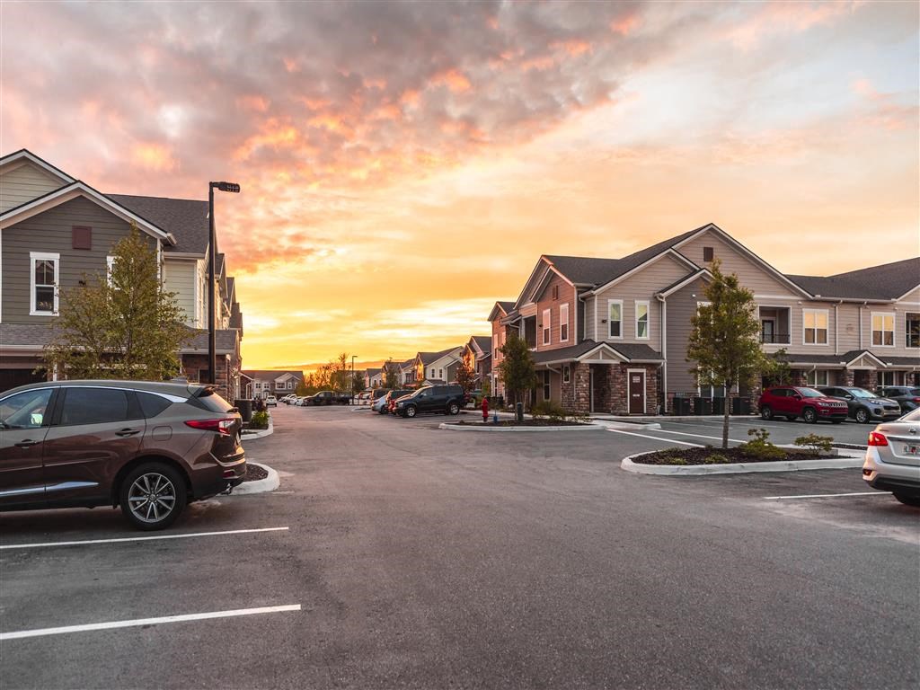 a row of houses with a sunset in the background at Verso Apartments, Davenport, Florida