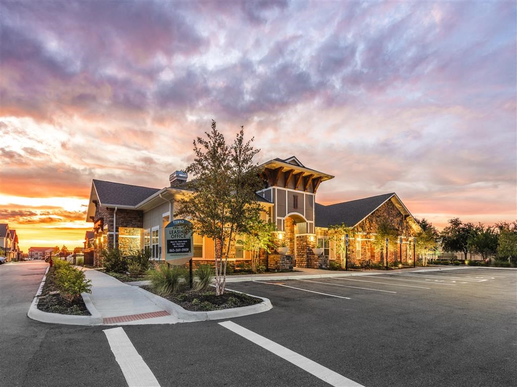 a building with a parking lot in front of it at Verso Apartments, Florida