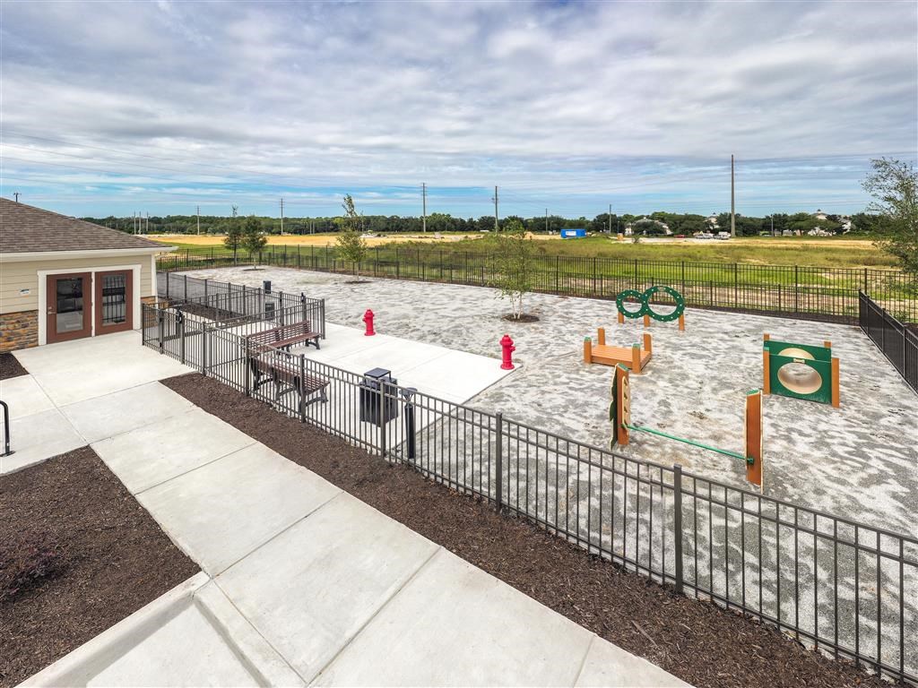 a park with a playground and a building in the background at Verso Apartments, Davenport, 33896