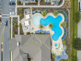 a pool in a backyard with a house and a car at Verso Apartments, Davenport, FL - Photo Gallery 4