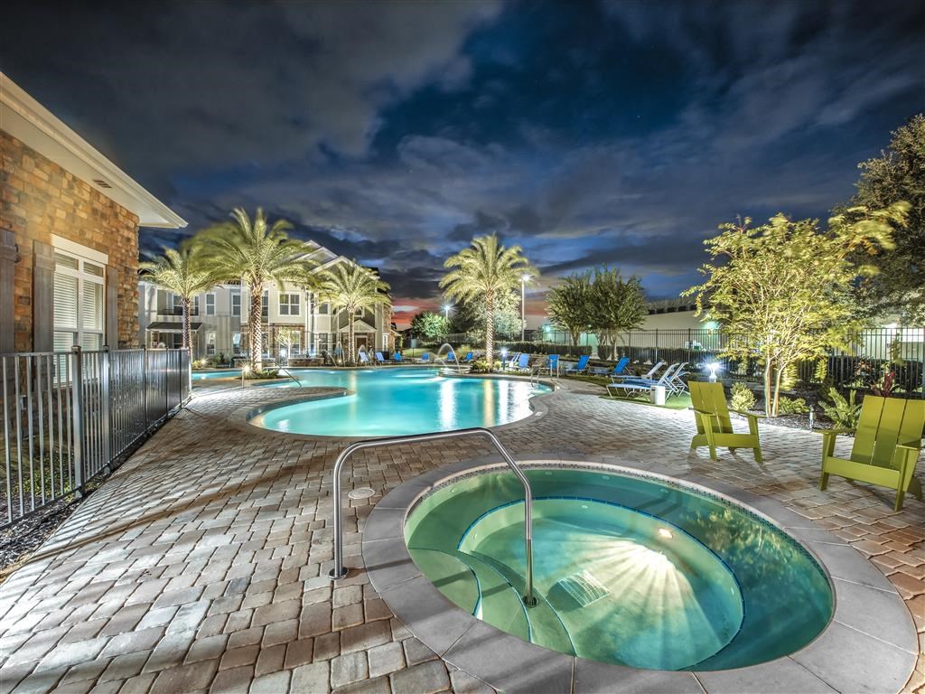 a swimming pool and hot tub at night at Verso Apartments, Florida, 33896