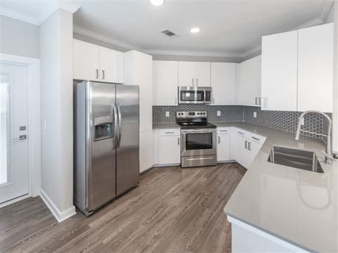 a kitchen with white cabinets and stainless steel appliances at Verso Apartments, Florida, 33896