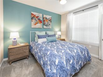a bedroom with a bed and two night stands at Verso Apartments, Davenport, FL - Photo Gallery 3
